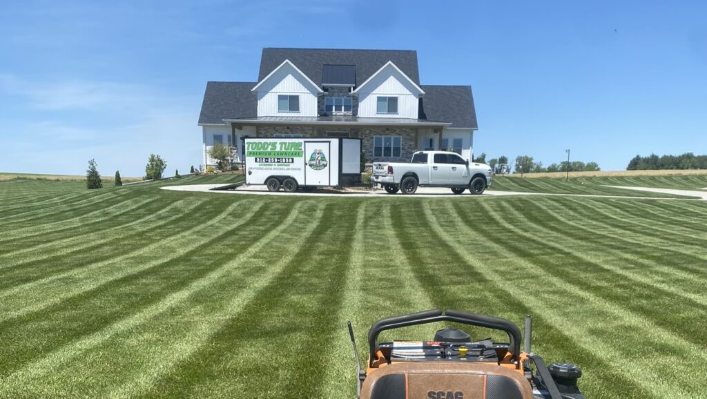 nice lawn with lawn mower and house with truck and trailer